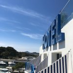 Sur le petit port de l'Ayguade à Hyères, La Reine Jane dresse sa façade années 50 et son enseigne «<small class="fine d-inline"> </small>HOTEL<small class="fine d-inline"> </small>» en capital XXL face aux îles d'Or